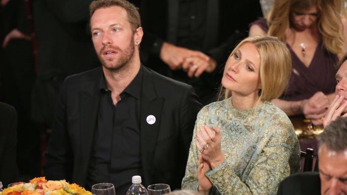 Chris Martin sitting at a table with Gwyneth Paltrow