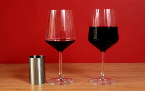 A glass holding a 125ml (small) measure of wine alongside a glass holding a third of a bottle