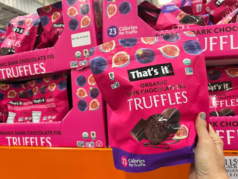 hand holding bulk package of that's it dark chocolate truffles at costco