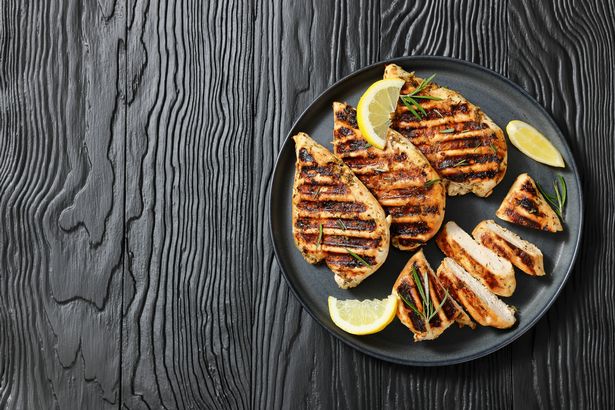 Grilled chicken breasts with lemon on a plate